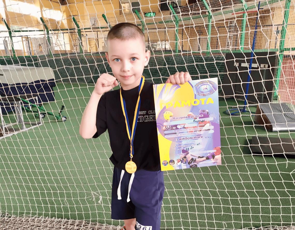 The boy with his award for excellent results at competition